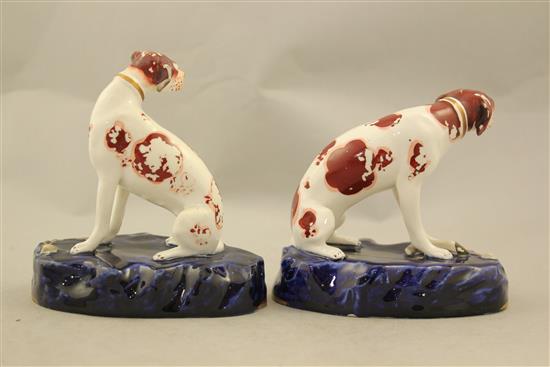 A pair of English porcelain figures of seated hounds, c.1830, 11.5cm and 12.5cm, flaking to enamels